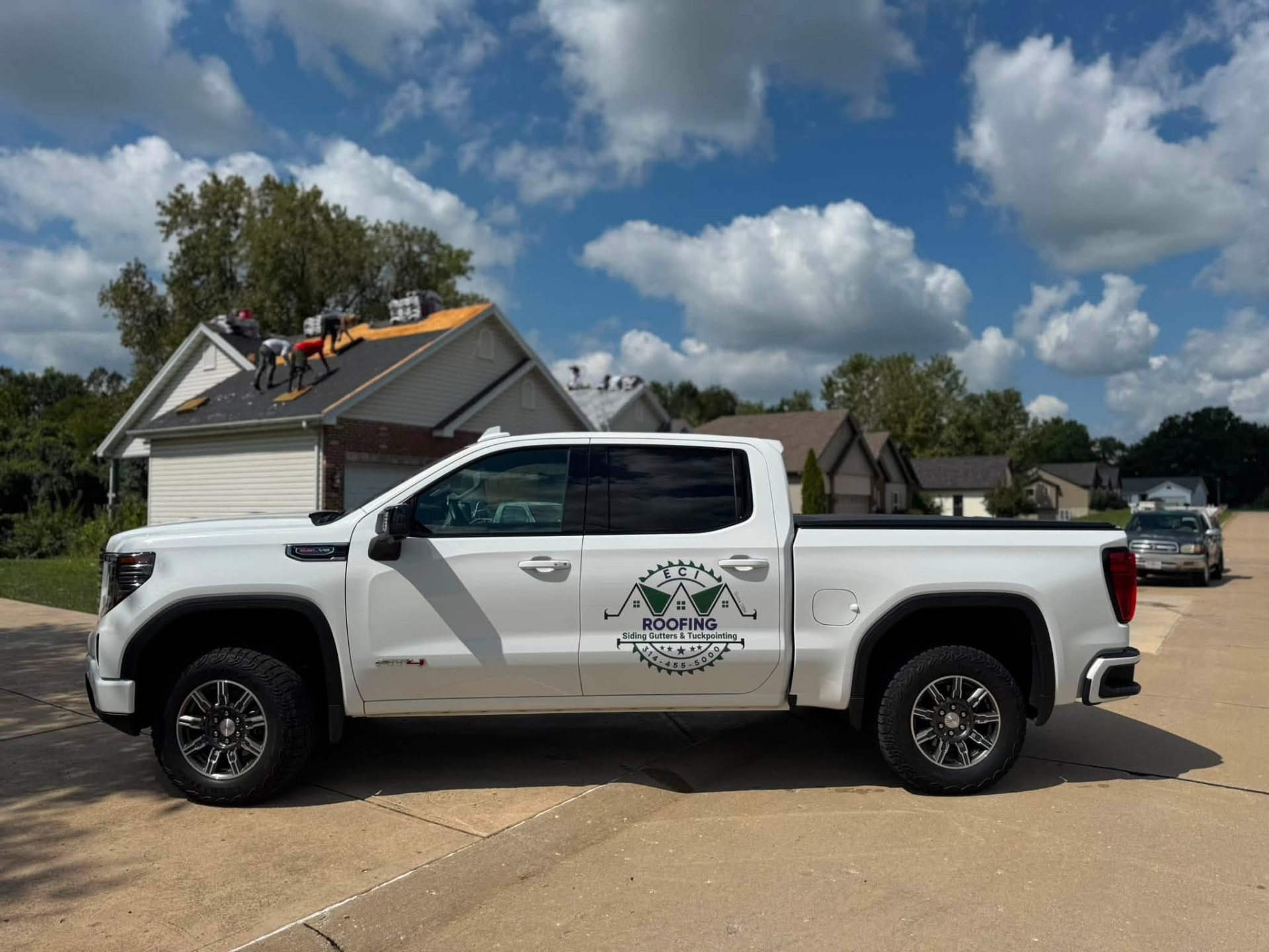 White ECI Roofing truck at an active residential roofing project in Missouri