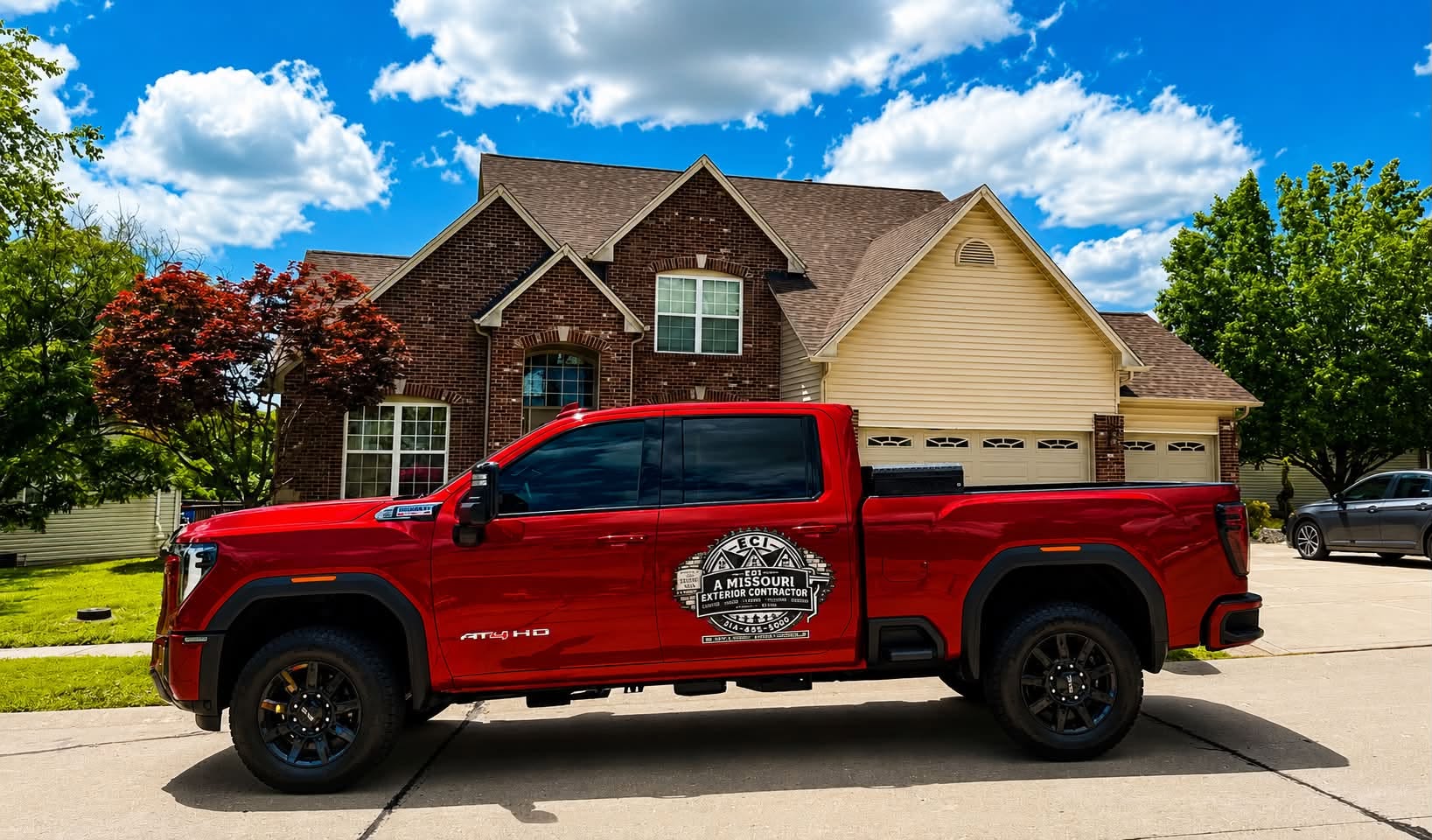 Red ECI: A Missouri Exterior Contractor truck in front of a Missouri home